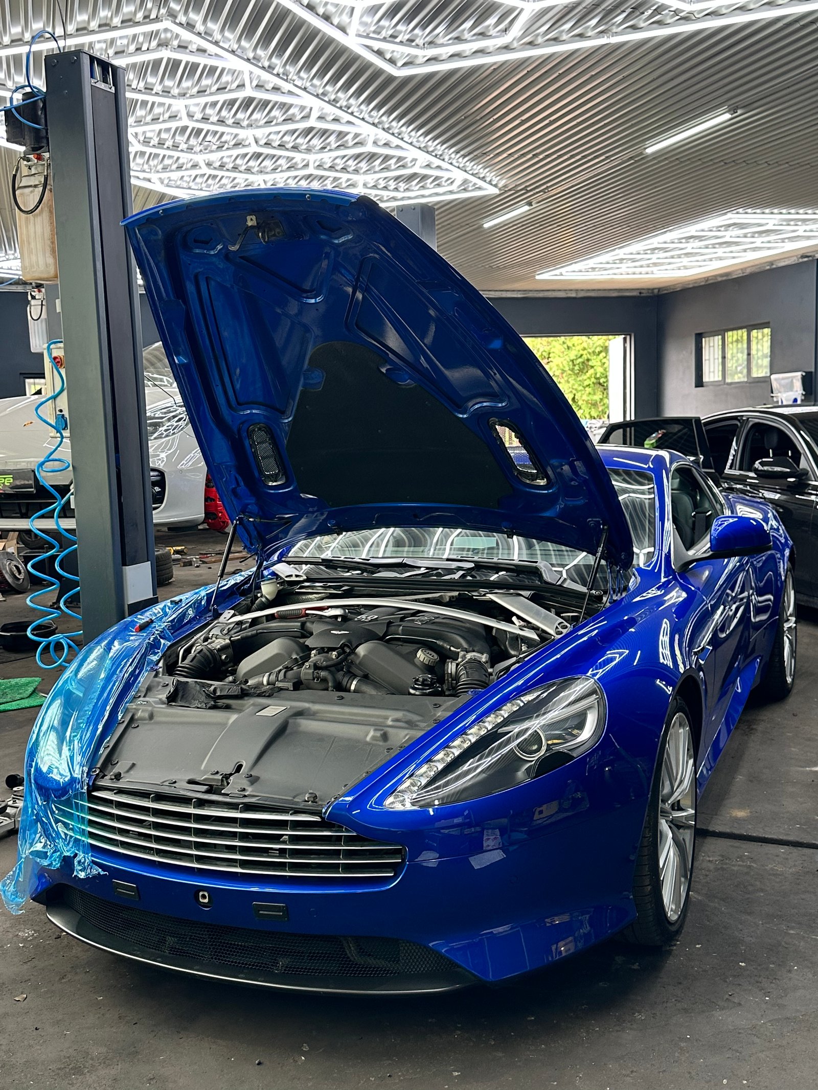 Blue Aston Martin engine in the workshop