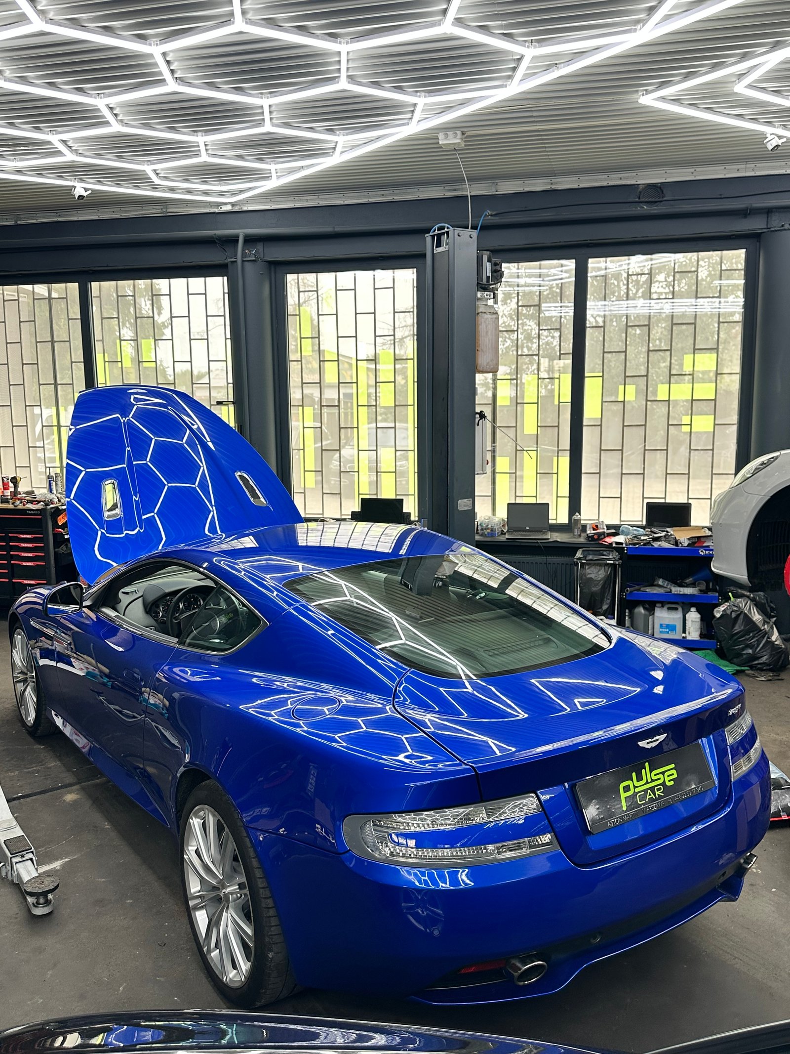 Blue Aston Martin in the workshop